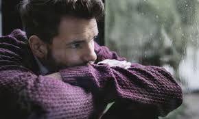 maN LOOKING OUT WINDOW